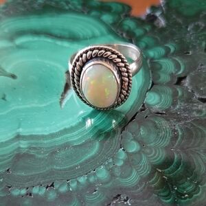 Vintage Sterling Silver and White Opal Ring with Intricate Detailing.